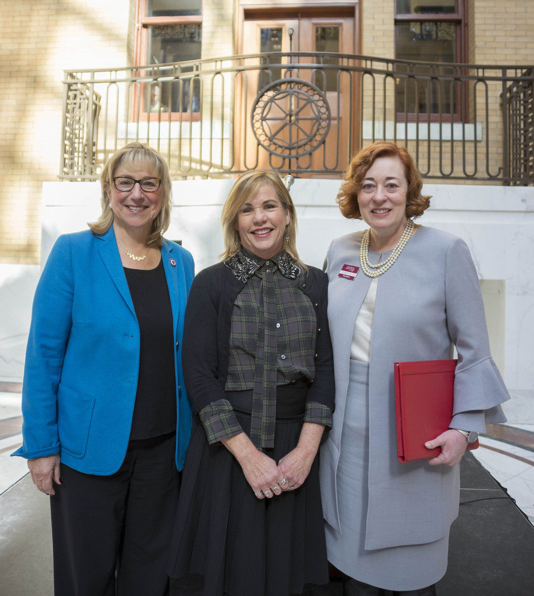 Three women standing inside government building